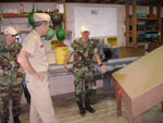 The completed cases are being viewed by Rear Admiral William French before transport to Peleliu.